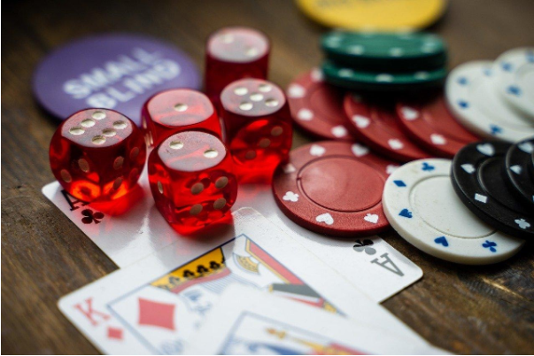 closeup of poker chips, playing cards and dice
